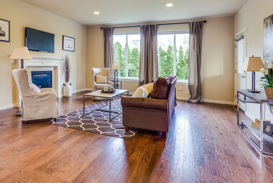 Furnished living room with a fireplace, leather sofa and hand-scraped hardwood floor